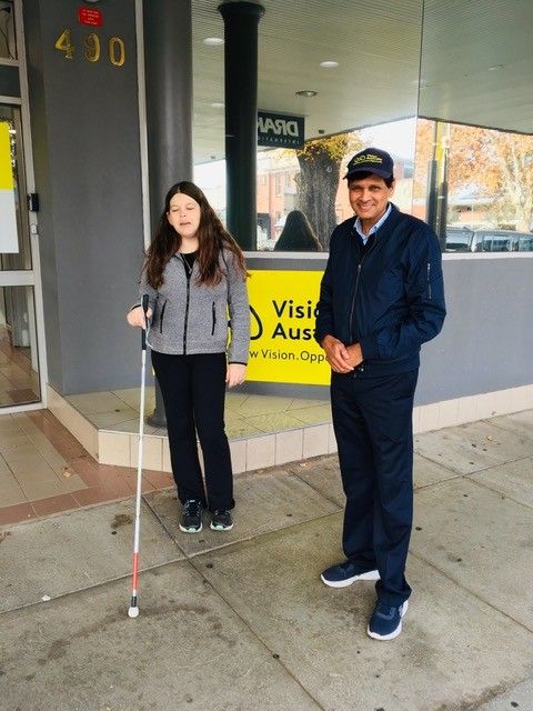 Maruthi with Vision Australia Career Start graduate Tess Herbert standing in front of Vision Australia offices in Albury